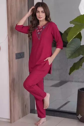 Women new rani pink solid kurta pant set with heavy neck embroidery