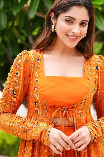 Orange digital print faux georgette sharara suit set with crop top & shrug stitched