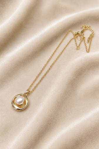 Gold-tone pearl pendant necklace with round swirl setting