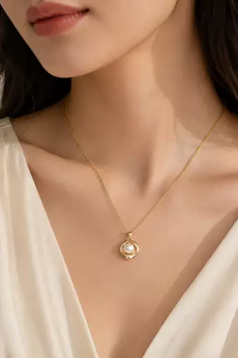 Gold-tone pearl pendant necklace with round swirl setting