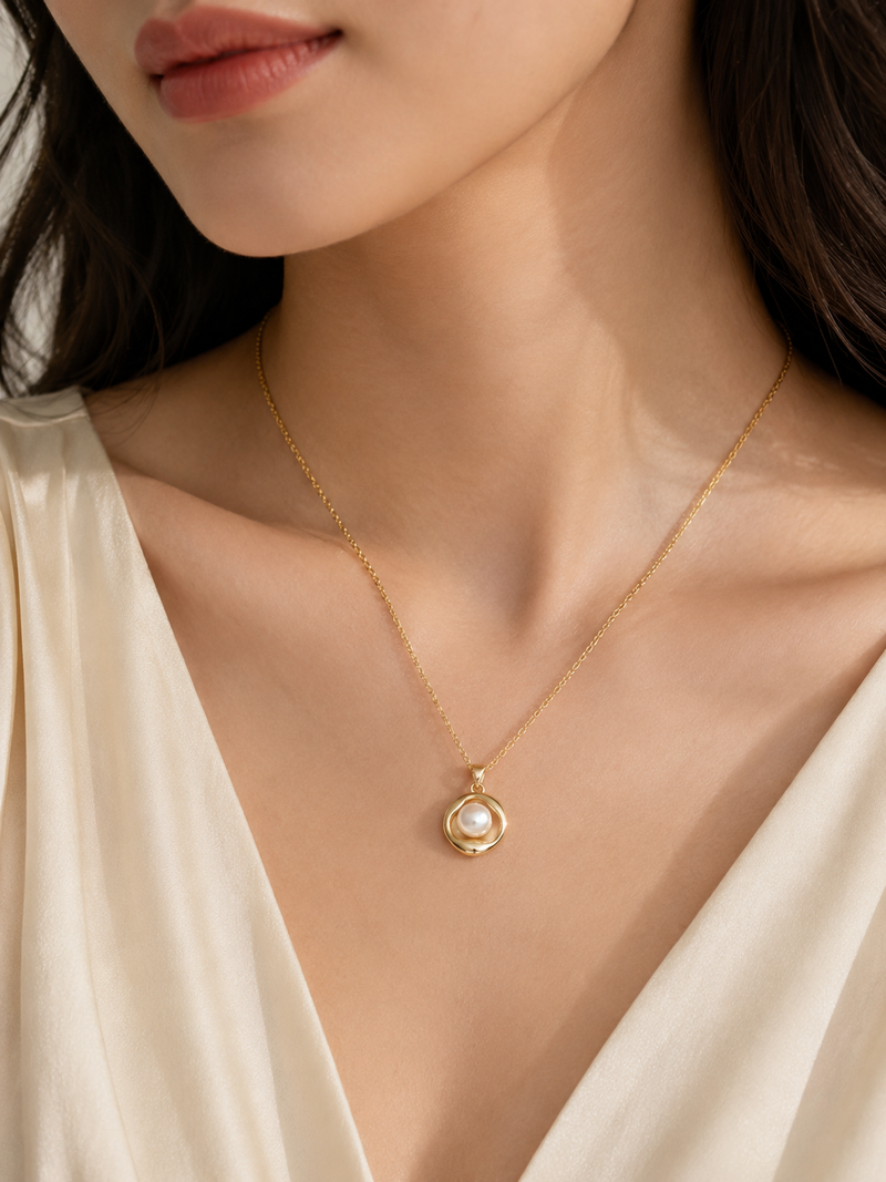 Gold-tone pearl pendant necklace with round swirl setting