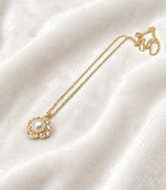 Pearl flower pendant necklace with crystal accents, gold tone