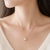 Pearl flower pendant necklace with crystal accents, gold tone