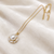 Pearl pendant necklace with crystal halo, gold-tone chain