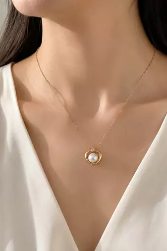 Pearl pendant necklace with gold-tone heart frame and crystal