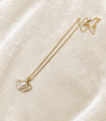 Pearl pendant necklace with ginkgo leaf design, gold chain