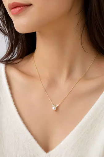 Pearl pendant necklace with crystal accents, gold chain