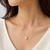 Pearl pendant necklace with crystal accents, gold chain