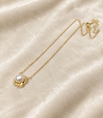 Pearl pendant necklace with gold-tone square frame