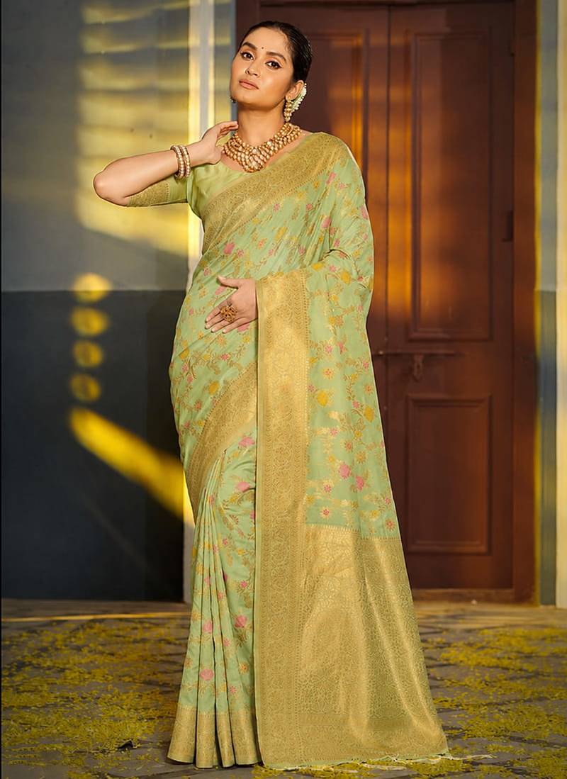 Light pistachio green banarasi silk blend saree with rich gold zari floral weaving
