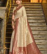 Cream banarasi silk blend saree with red zari border