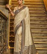 Cream banarasi silk blend saree with navy blue zari border