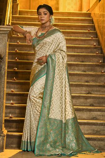 Cream banarasi silk blend saree with sea green zari border