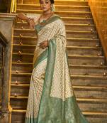Cream banarasi silk blend saree with sea green zari border