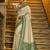 Cream banarasi silk blend saree with sea green zari border