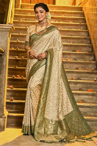 Cream banarasi silk blend saree with dark green zari border