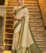 Cream banarasi silk blend saree with dark green zari border