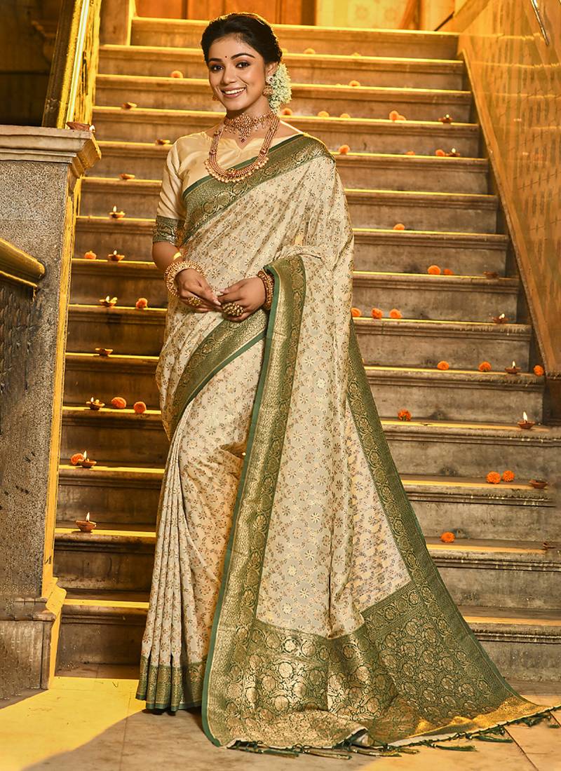 Cream banarasi silk blend saree with dark green zari border