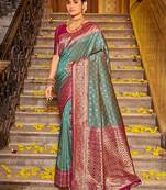 Teal blue banarasi silk blend saree with magenta zari border