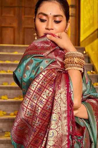 Teal blue banarasi silk blend saree with magenta zari border