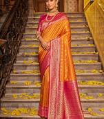 Orange banarasi silk blend saree with magenta zari border