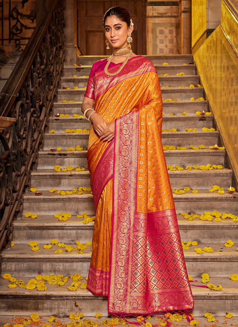 Orange banarasi silk blend saree with magenta zari border
