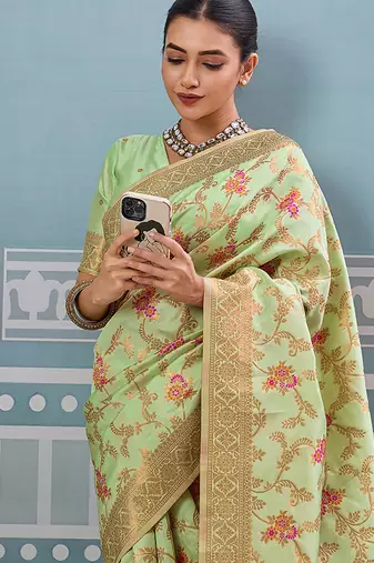 Light pistachio green banarasi silk blend saree with rich gold zari floral weaving