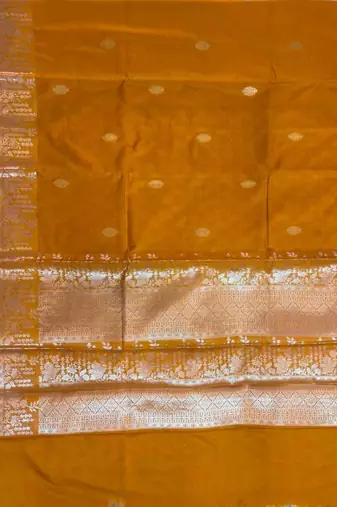 Mustard semi kataan silk banarasi saree with silver zari booti work
