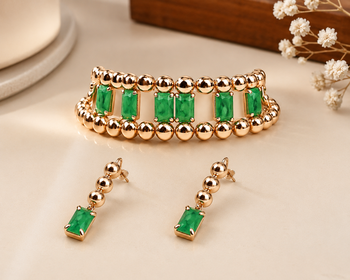 Gold-toned bracelet and drop earrings set with green stones 1