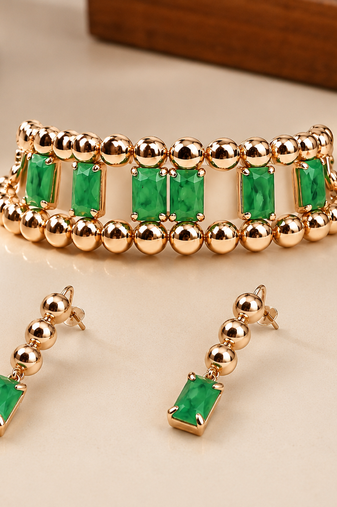 Gold-toned bracelet and drop earrings set with green stones