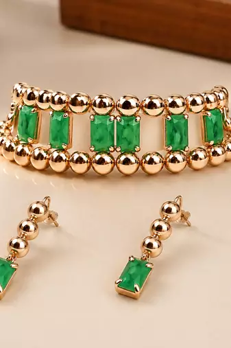 Gold-toned bracelet and drop earrings set with green stones