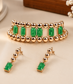 Gold-toned bracelet and drop earrings set with green stones
