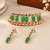 Gold-toned bracelet and drop earrings set with green stones