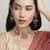 glimmery oval and leaf pearl lariat brass kundan antique gold plated choker jewellery set for women