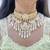 white kundan choker set with maang tikka