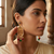 Traditional antique gold-plated chandelier drop earrings with pearls, red & green beads