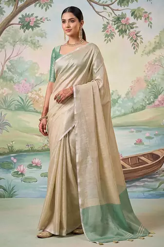 Beige tissue linen blend saree with sea green contrast blouse