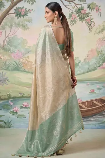 Beige tissue linen blend saree with sea green contrast blouse
