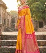 Mustard banarasi silk blend saree with rani pink zari border