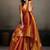 Rust orange linen silk blend saree with gold zari bootas and tassels