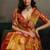 Rust orange linen silk blend saree with gold zari bootas and tassels