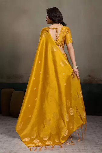 Mustard yellow linen silk blend saree with gold zari bootas and tassels