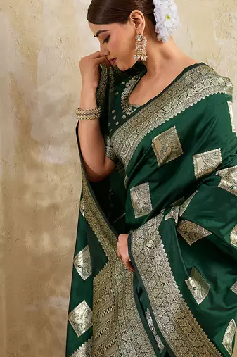 Dark green zari woven banarasi silk blend saree with blouse piece