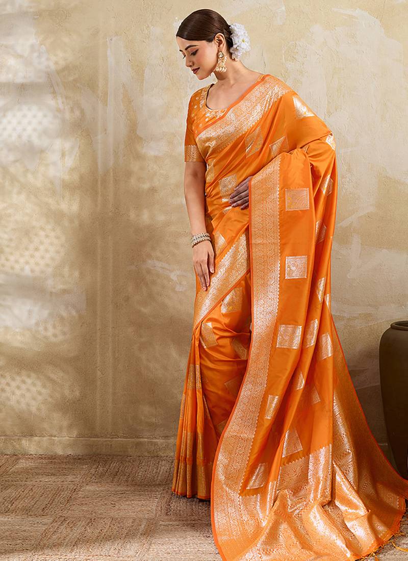Orange zari woven banarasi silk blend saree with blouse piece