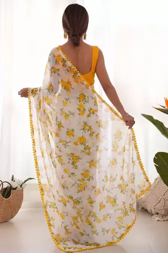 Yellow heavy chiffon printed lace border saree with blouse