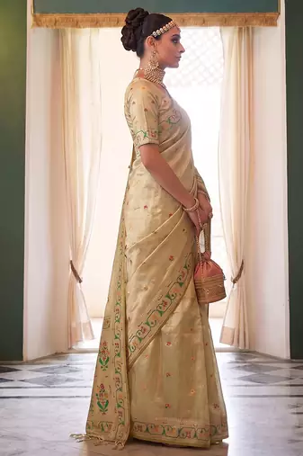 Cream tissue silk blend saree with paithani border and floral pallu