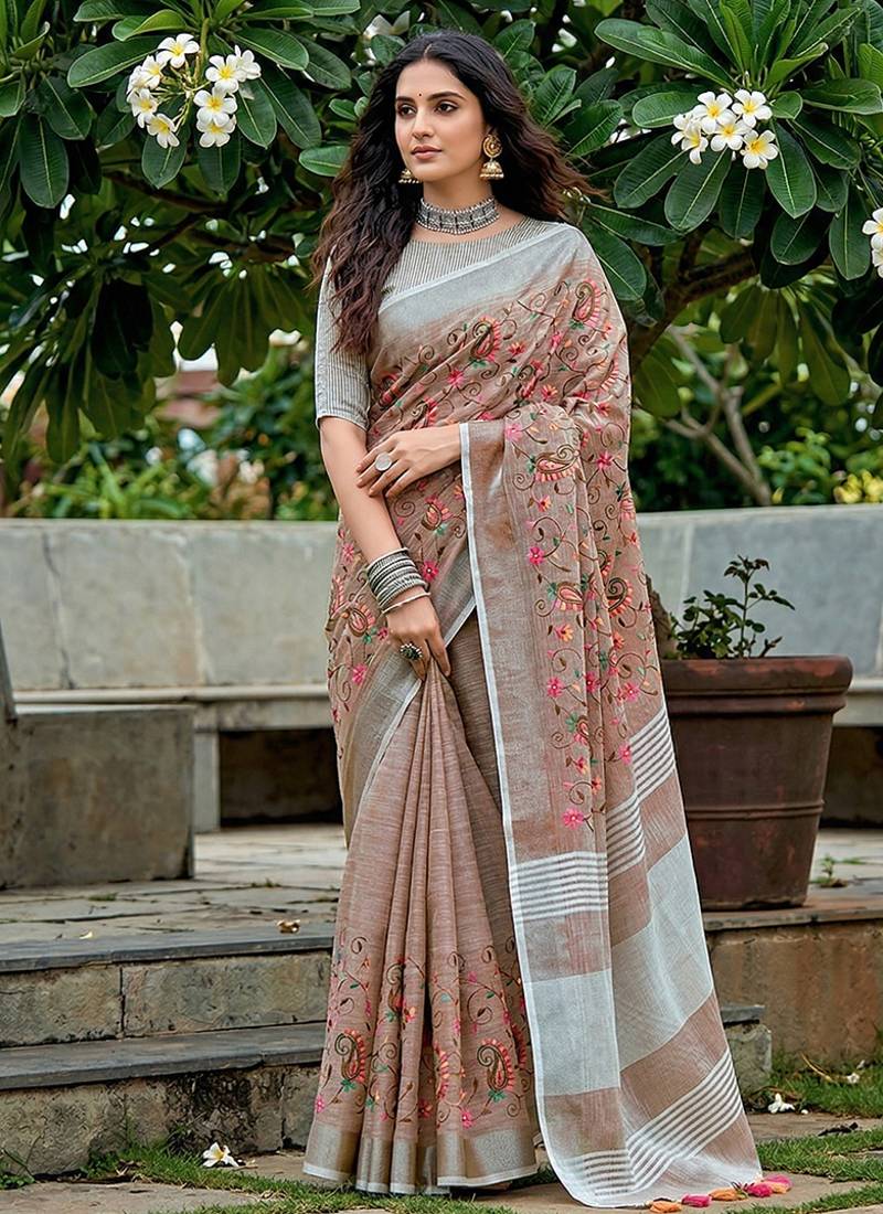 Brown linen cotton blend saree with floral embroidery & tassel pallu