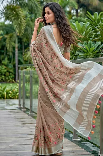 Brown linen cotton blend saree with floral embroidery & tassel pallu