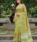 Pista green linen cotton blend saree with floral embroidery & tassel pallu
