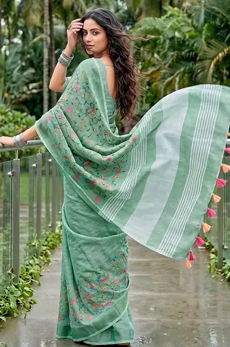 Sea green linen cotton blend saree with floral embroidery & tassel pallu